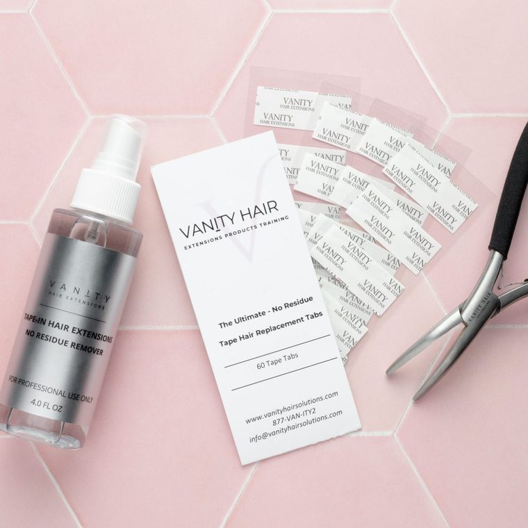 Tape Extension Removal Kit — remover bottle, tab card, tabs and pliers on pink tile