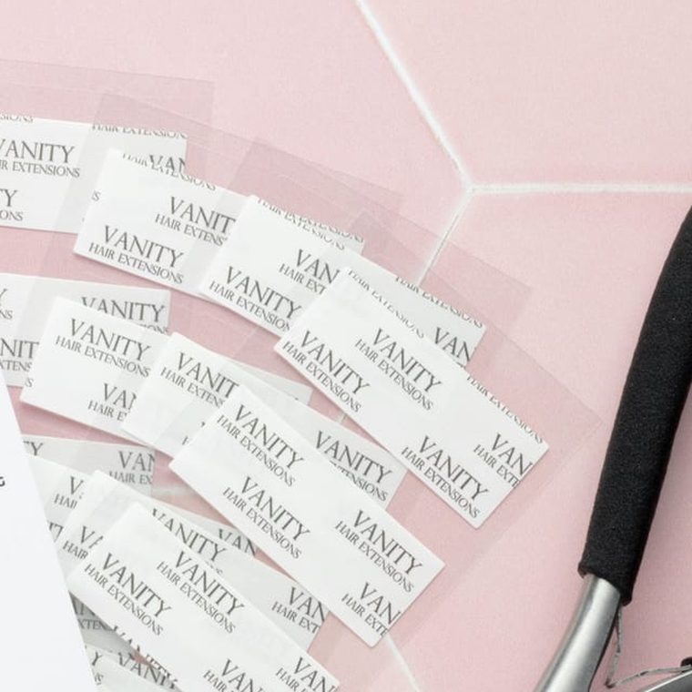 Vanity replacement tape tabs fanned out on pink hexagon tile