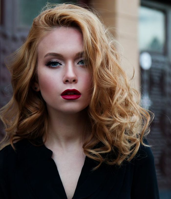 Warm copper blonde hair styled in a voluminous blowout